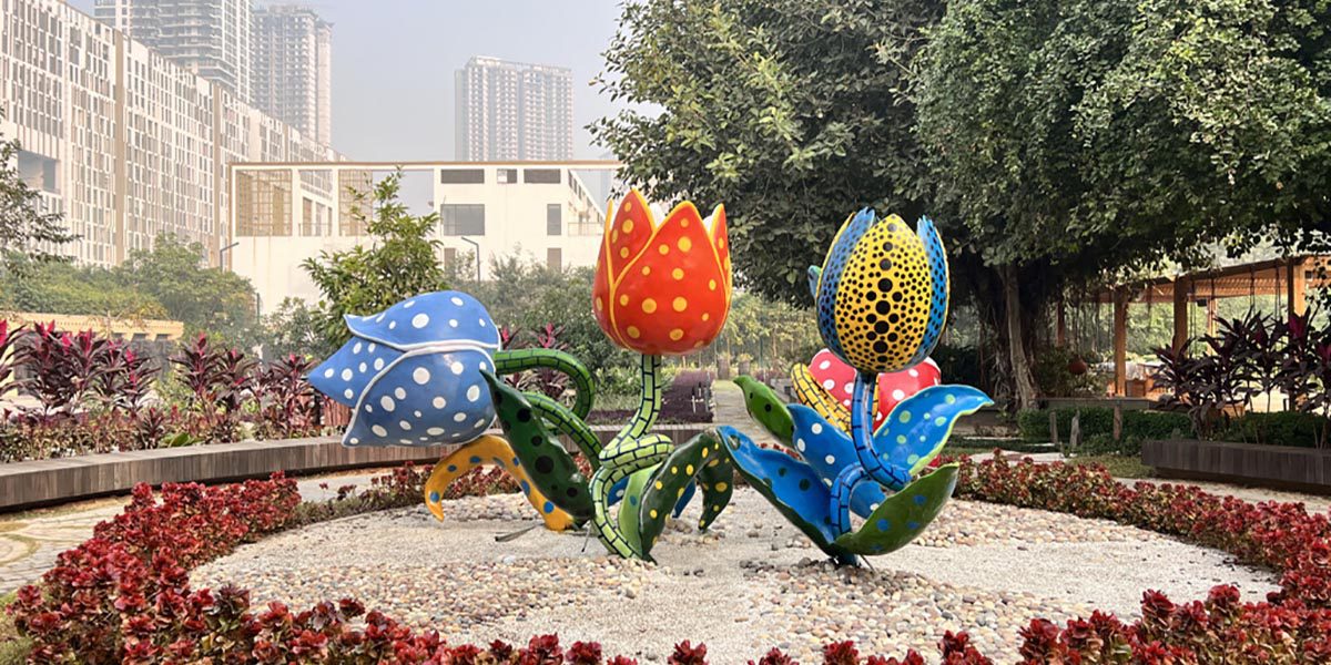 Colourful tulip sculptures in a landscaped garden